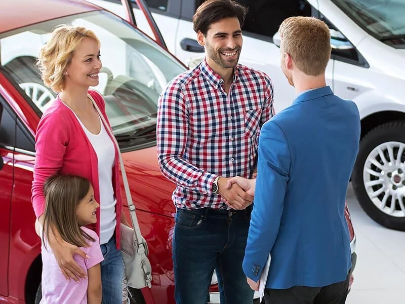 Family shaking hands with sales representative | Colussy Chevrolet in Bridgeville PA